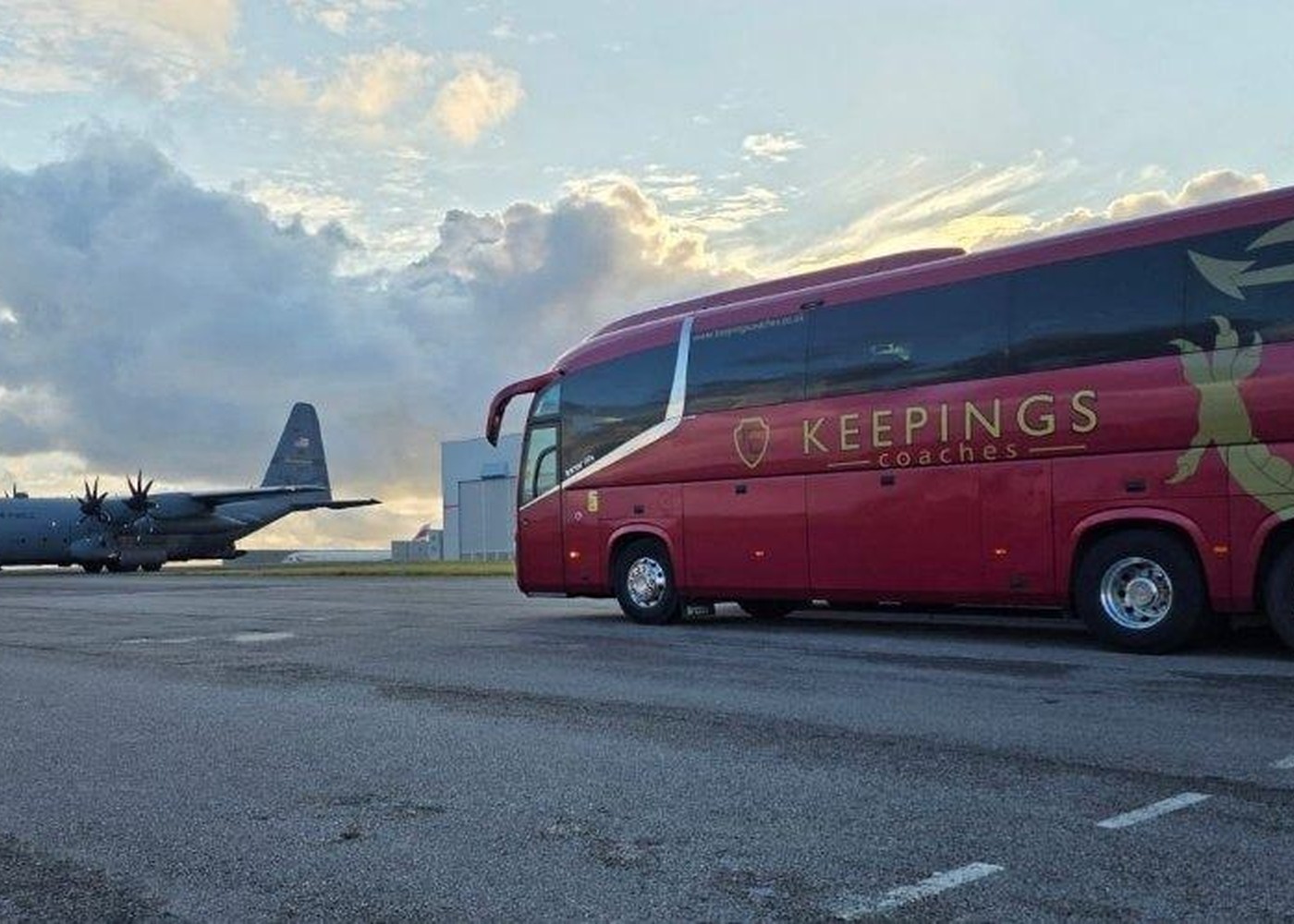 Keepings Coaches red coach on airport transfer work