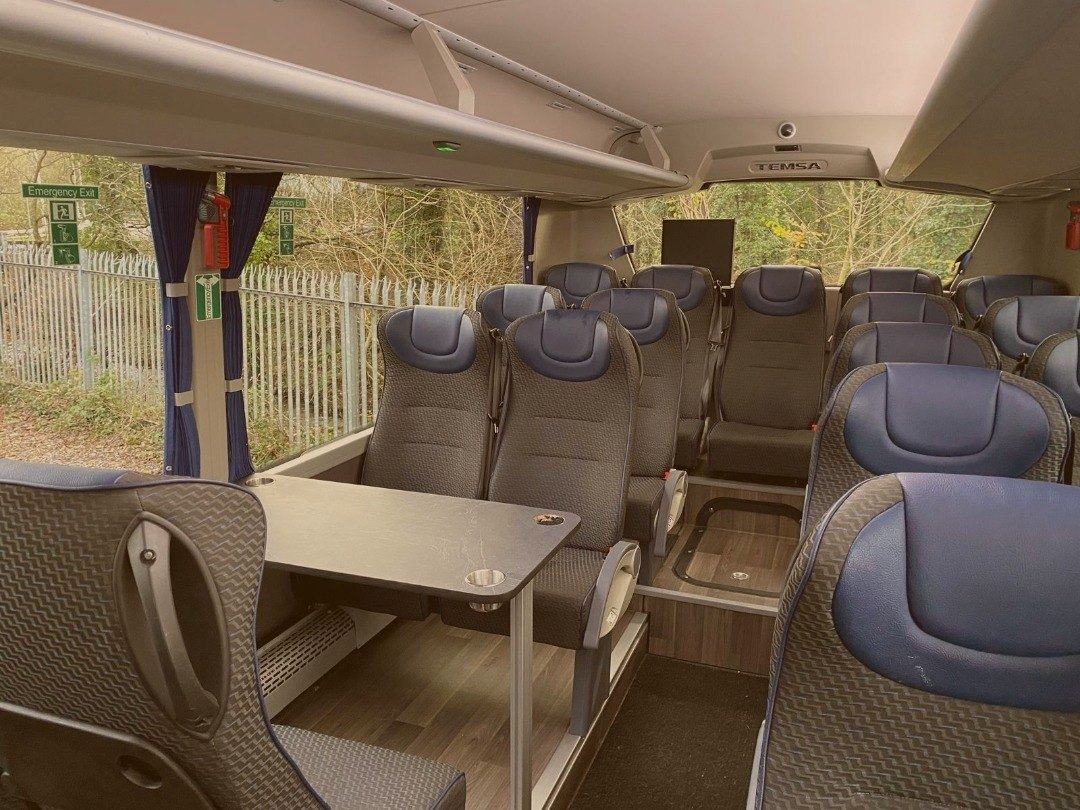 Table seating inside the 47-seat coach